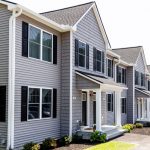 Newly-installed siding and windows on Saddle Rock Way end-unit, located in Manchester, New Hampshire