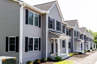 Newly-installed siding and windows on Saddle Rock Way end-unit, located in Manchester, New Hampshire