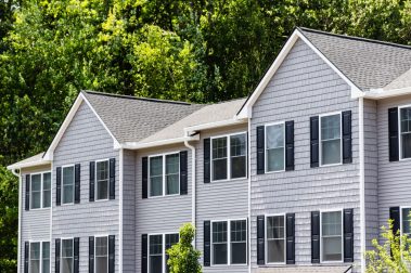 Manchester, NH residential townhouse community surrounded by fully bloomed trees and landscaped walkways